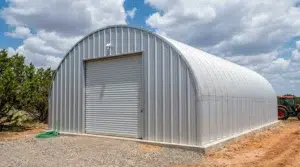 Durable steel Quonset hut in Alberta under a cloudy sky.