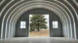 Interior view of a steel Quonset hut with open doors in Alberta.