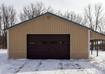 Front elevation of a 24x30 steel maintenance shop in winter.