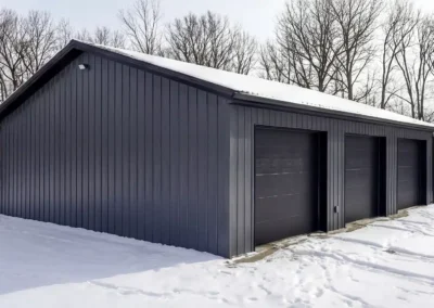 24x36 steel triple car garage with snow and forest background