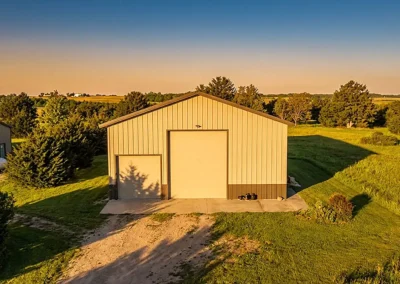 Aerial view of 40x60 modern steel hay storage barn at sunset.