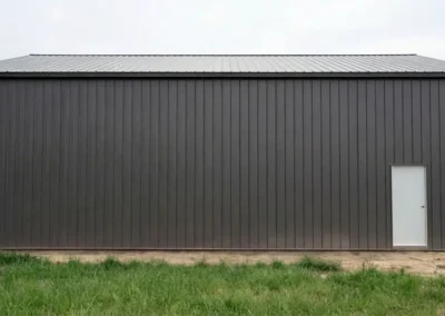 Modern steel farm equipment storage facility with side wall profile
