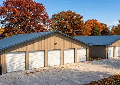Steel construction business plaza with multiple garage units in autumn setting
